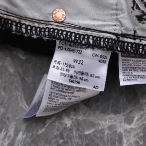 Levi's jeans W32 size white denim cotton fabric with Levi Strauss branding on copper rivet button