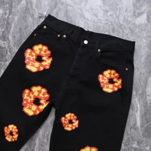 Given the rules and the image provided: There is no brand or model number visually present on the jeans in this image, so I can't generate a complete SEO-optimized alt text precisely as instructed. However, here is an optimized alt text suggestion based on visible attributes of the product type: Black jeans with red and yellow abstract floral prints on denim material