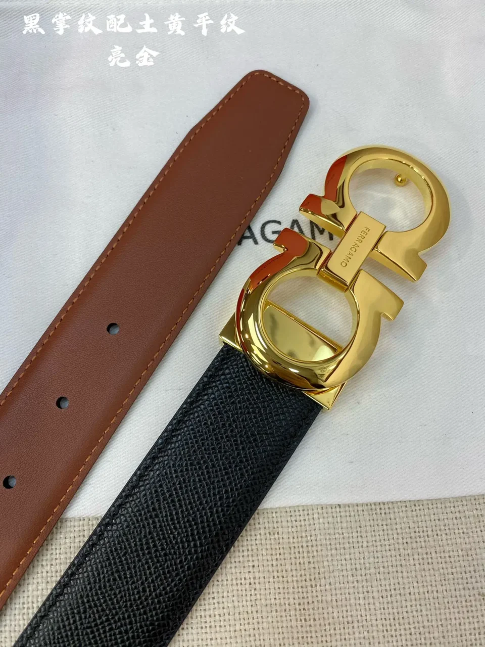 Ferragamo belt black textured leather with gold double G buckle and brown leather strap