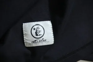 Hellstar clothing tag black fabric cotton garment label with brand logo and authenticity note