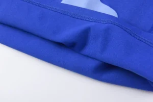 Repsgoat blue cotton fabric close-up with detailed stitching and soft texture