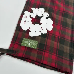Denim Tears flannel shirt red black brown plaid cotton fabric with white floral graphic and green brand label