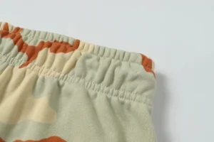 Camo print waistband of Denim Tears high-quality cotton flower hair sweatpants, showcasing fabric texture and design details.