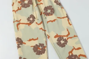 Camo printed sweatpants featuring floral designs, part of the Denim Tears high-quality cotton collection, available in various sizes.