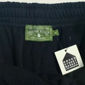 Denim Tears knit shorts black cotton blend with green brand label and Dover Street Market Los Angeles tag