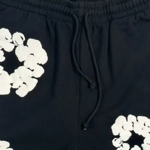No brand visible black shorts with white floral graphic print and drawstring waistband cotton material