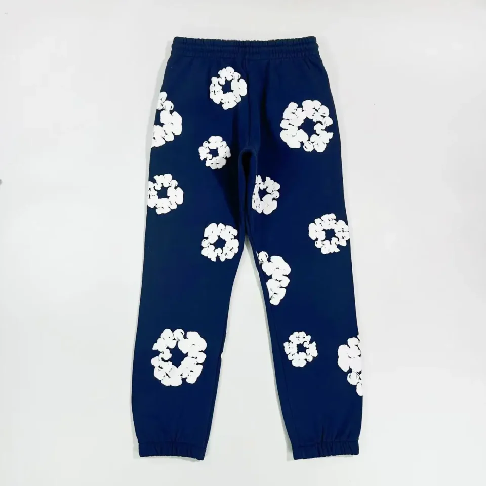 No brand or model information visible for navy blue sweatpants with white floral pattern, cotton material