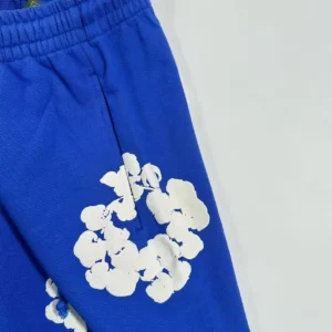 No brand visible, blue sweatpants with white floral print, cotton fabric