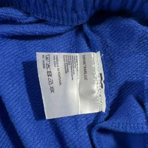 Denim Tears LLC fabric tag blue cotton garment made in Portugal with care instructions