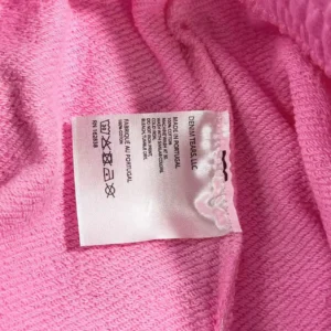 Denim Tears LLC cotton fabric care label pink textile material made in Portugal