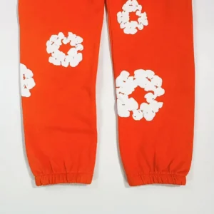Supreme fleece sweatpants orange cotton with white floral graphic print and elastic cuffs