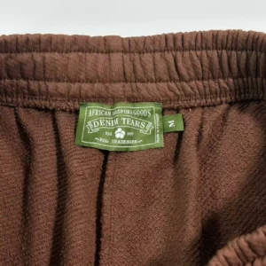 Denim Tears sweatpants brown cotton fabric elastic waistband medium size tag close-up