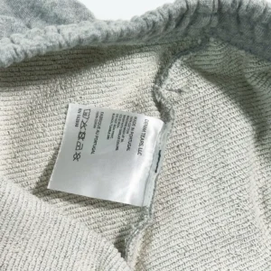 Label tag inside Denim Tears Main Line Hemp Grey Cotton shorts, featuring care instructions and fabric details.