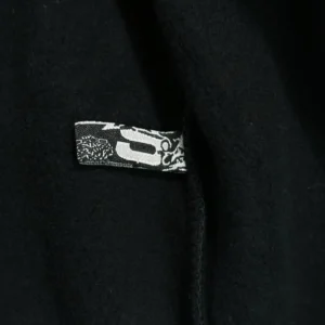 Label tag of the Sder Black and Red OG Hot Diamond Bead Mesh Hoodie featuring SP5DER branding, showcasing fabric texture and design details.