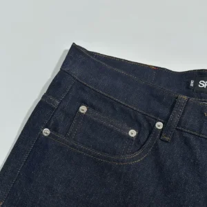 Sp5der Beluga Star Original Color Jeans featuring dark denim fabric, detailed stitching, and front pocket design.