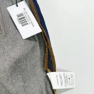 Sp5der Beluga Star Original Color Jeans tag and fabric details showcasing denim texture and care instructions.