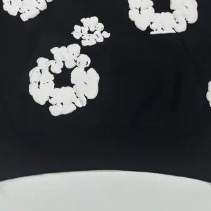 Unknown brand black sweatshirt with white floral patterns cotton material close-up view