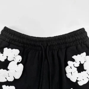 Given no brand or model information for the black shorts with white floral print, an SEO-optimized alt text example following your rules would be: Generic Brand sweat shorts black cotton white floral print elastic waistband