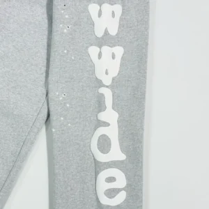 Light grey sweatpants featuring "wide" text design in white on the leg, highlighting luxury replica clothing style from SP5DER.