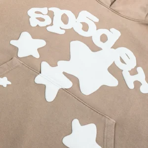 Sder Camel Beluga Hoodie 05 featuring white star designs and SP5DER logo on beige fabric, showcasing trendy streetwear style.