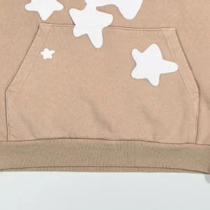 Sder Camel Beluga Hoodie 05 featuring a beige fabric with white star designs on the front pocket, showcasing trendy streetwear style.