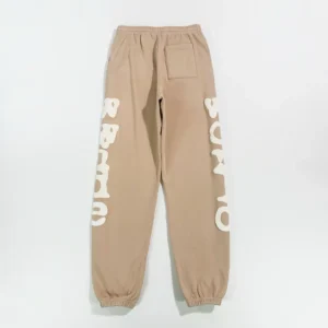 Sder Camel Beluga Sweatpants 05 in beige with bold white branding, featuring an elastic waistband and cuffed ankles, showcased for e-commerce purchase.