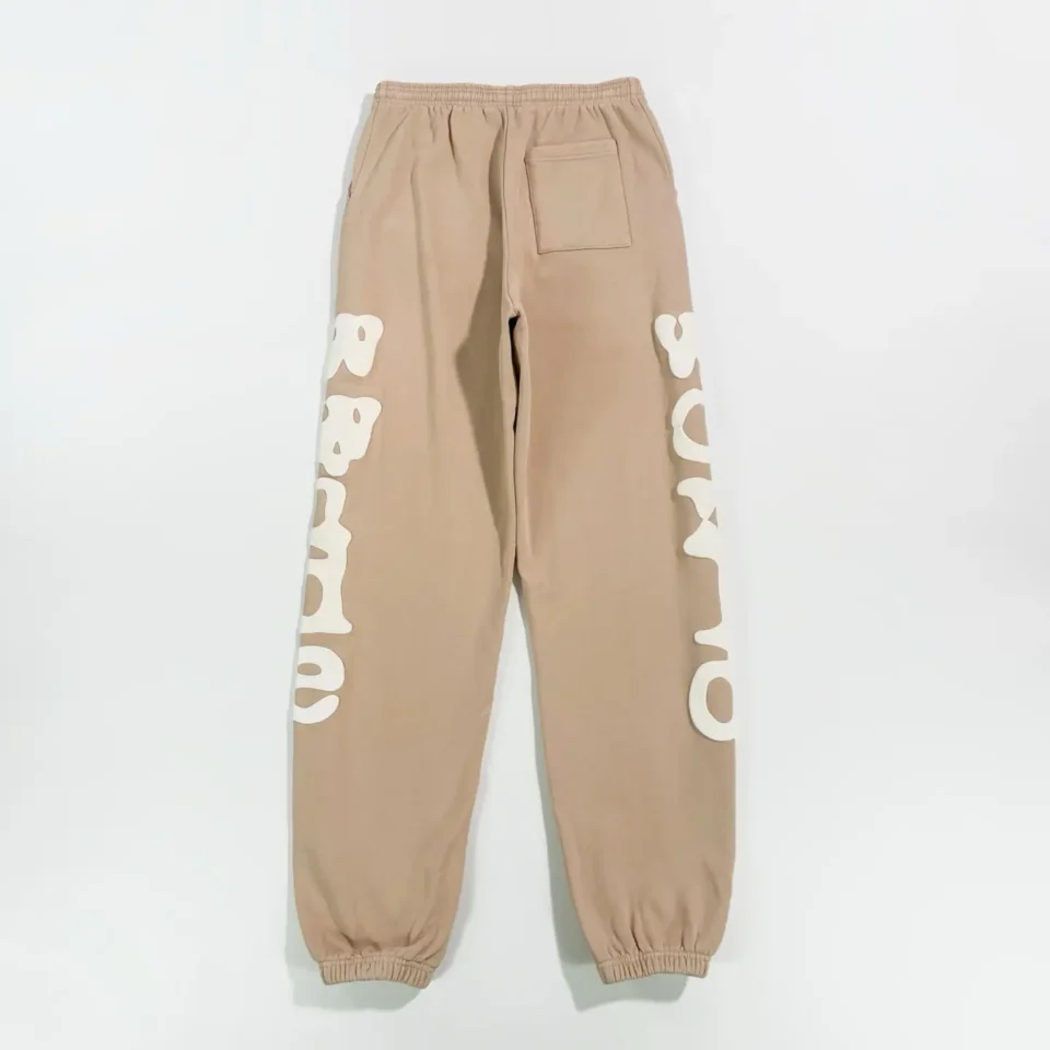 Supreme sweatpants tan beige cotton fleece with large white logo print and elastic cuffs