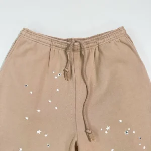 Sder Camel Beluga Sweatpants 05 featuring star embellishments and drawstring detail, showcasing high-quality fabric for designer replica apparel.
