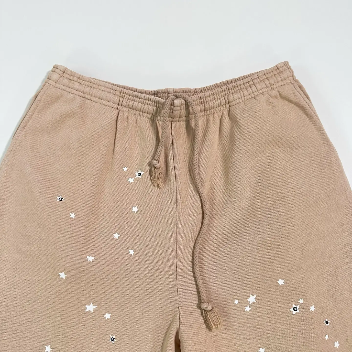 Sder Camel Beluga Sweatpants 05 featuring star print design and drawstring waistband, highlighting fabric quality for affordable replica apparel.