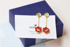 Swarovski earrings red crystal flower gold-tone metal long dangle accessory with swan logo detailing