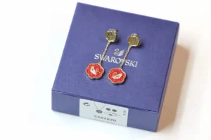 Swarovski earrings red flower design gold-tone metal dangle delicate chain accessory