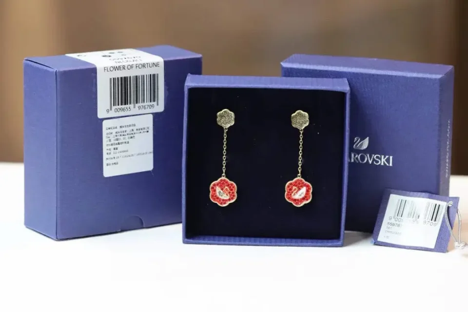 Swarovski earrings Flower of Fortune red crystal gold-tone metal dangle earrings with chain and flower design