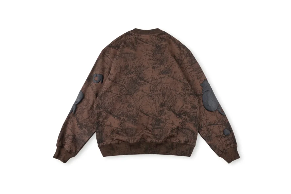 No brand or product type provided for the brown patterned long sleeve garment shown from the back. Please provide those details.