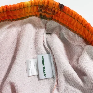 Denim Tears shorts orange multicolor elastic waistband cotton material clothing label close-up