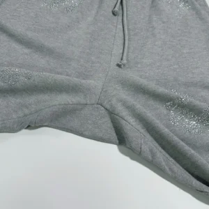 Grey sweatpants featuring diamond embellishments, part of the Denim Tears Grey Water collection, highlighting premium craftsmanship and unique design elements.