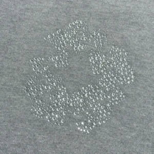 Grey cotton fabric featuring a diamond-patterned floral design made of sparkling rhinestones, representing the Denim Tears Grey Water Diamond Cotton Flower product.