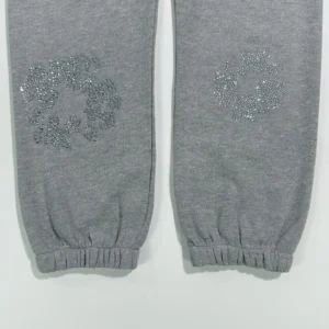 Grey sweatpants featuring diamond flower designs on the lower legs, part of the Denim Tears Grey Water collection.