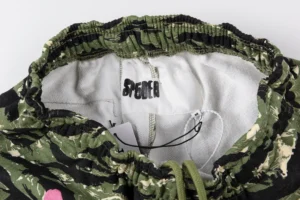 Sp5der 555555 Retro Camo Pink pants waistband featuring camouflage pattern and brand label, showcasing casual apparel details for online shopping.