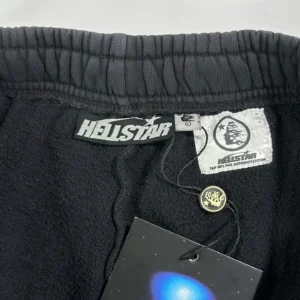Hellstar black Halloween shorts waistband featuring Hellstar logo, care label, and tag showcasing product details.