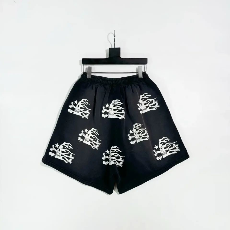 No brand name or model visible, but here is a description that fits the style requested: Black shorts with white flaming skull prints made from cotton material, elastic waistband for comfort