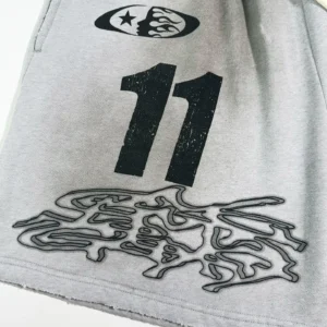 Brain Dead Number 11 Grey cotton shorts with black graphic print and raw hem detailing