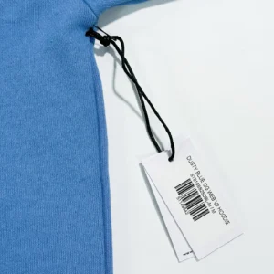 Off-White Dusty Blue OG Web V2 hoodie medium cotton fabric with product tag and barcode close-up