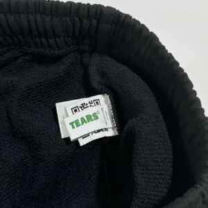 TEARS brand black cotton fabric with logo label and QR code tag close-up