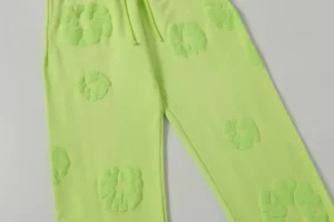 Denim Tears new cotton flower pants in fluorescent green with foam flower appliqués, showcasing a casual style for clothing enthusiasts.