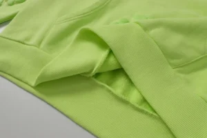 Casual looped hoodie in fluorescent green from Denim Tears' Cotton Flower Collection, showcasing soft cotton fabric and detailed stitching.