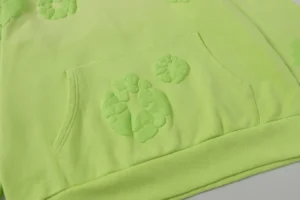 Casual looped hoodie from Denim Tears' Cotton Flower Collection in fluorescent green, featuring foam flower designs and front pockets.