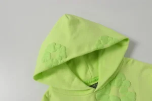 Casual looped hoodie from Denim Tears' Cotton Flower Collection in fluorescent green, featuring foam flower accents on the hood.