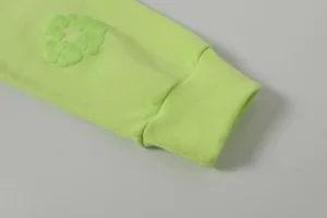Casual looped hoodie sleeve in fluorescent green with foam flower design, part of the Denim Tears New Cotton Flower Collection.