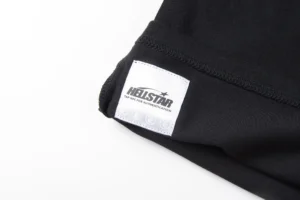 Hellstar Studios logo tag on a black T-shirt, showcasing the brand's identity and quality craftsmanship.