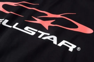 Hellstar Studios NS logo printed on pure cotton T-shirt, featuring a black background with vibrant pink design elements.